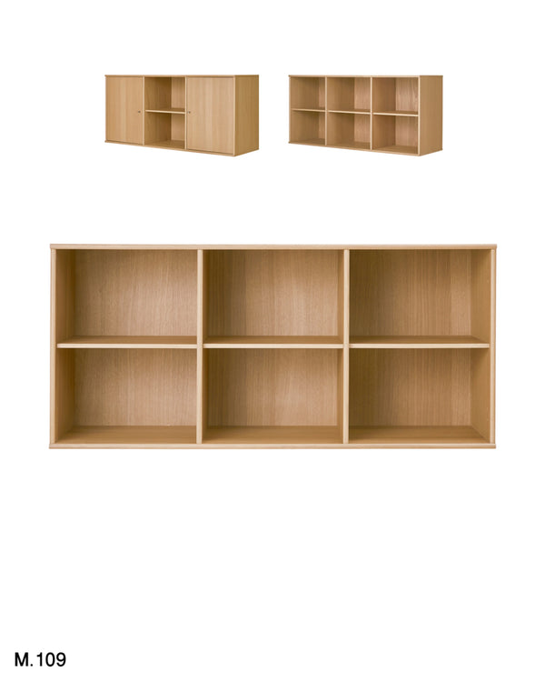 A light natural wood 6-compartment bookcase shown from the front, with two smaller angled views above it on a white background. The text 'M.